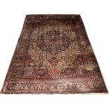 ANTIQUE PERSIAN KERMAN RUG, 9' 8" X 6' 9"Having a central medallion, five borders in colors of