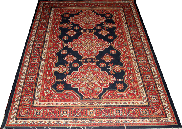 SERAPI STYLE RUG, W 6' 6", L 9' 1"A machine made rug in the Serapi style, having 8 borders, navy and