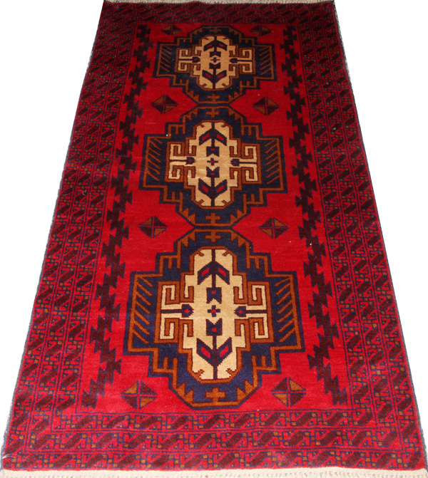 PERSIAN LURI WOOL RUG, C. 1950-1980, W 3' 5", L 6' 7"Red ground with 3 large geometric medallions.