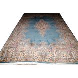 PERSIAN KERMAN WOOL CARPET, W 9' 6", L 13' 7"Having a blue field, central medallion and designs in