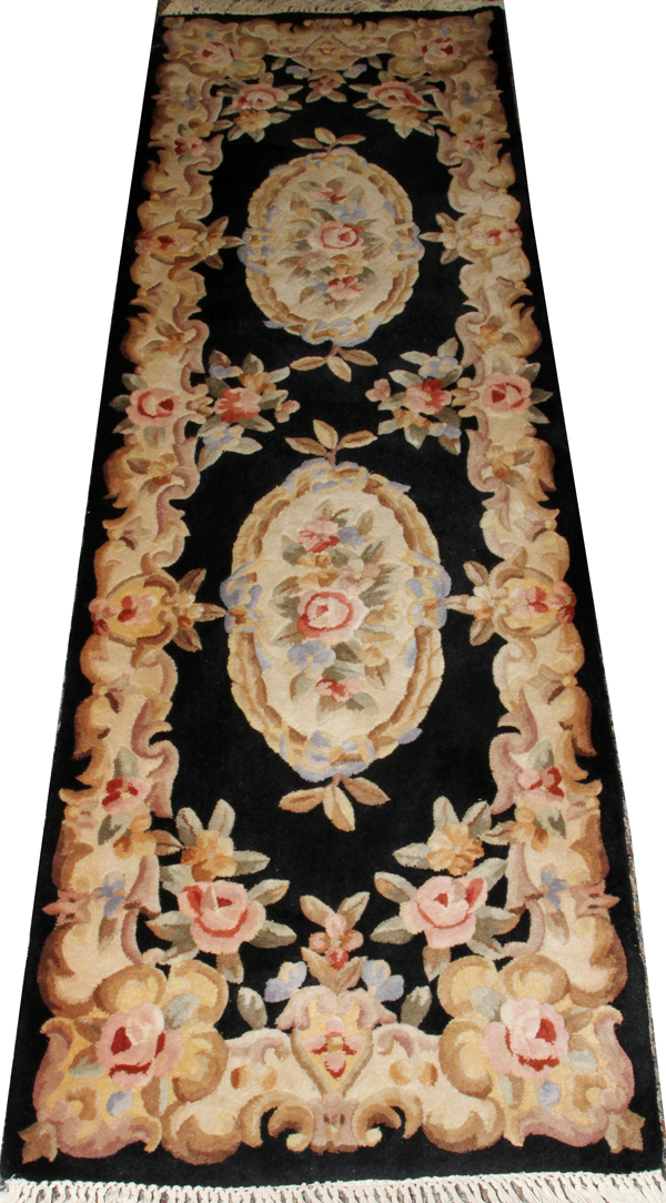 AUBUSSON DESIGN WOOL RUNNER, MODERN, L 9' 1"Having a black ground with two floral medallions and