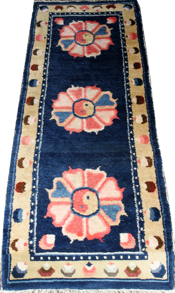 TIBETAN SINO PEKING WOOL RUNNER, H 2' 4", W 6' 4"With a 'ying yang' design in the center of a pink