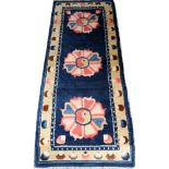 TIBETAN SINO PEKING WOOL RUNNER, H 2' 4", W 6' 4"With a 'ying yang' design in the center of a pink