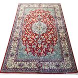 FINE SAROUK PERSIAN RUG, 10' 10" X 6' 9"Red ground with central medallion and overall scrolling