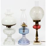 VINTAGE AND MODERN OIL LAMPS, THREEThe oil lamps include one with a pressed glass base, milk glass