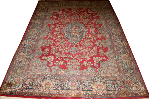 KERMAN PERSIAN WOOL RUG, W 8' 10", L 13' 8"Circa 1920, fine weave, red field.Nice condition.- For