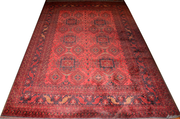 TEKKE BOKHARA WOOL CARPET, W 6' 7", L 9' 8"An overall red ground and design, with gold leaves