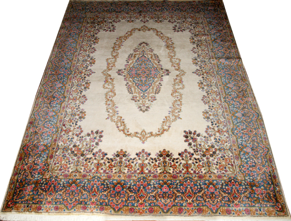 PERSIAN KERMAN WOOL CARPET, W 8' 11", L 12'Having an ivory field, central medallion and designs in