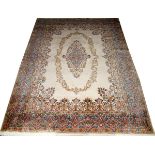 PERSIAN KERMAN WOOL CARPET, W 8' 11", L 12'Having an ivory field, central medallion and designs in