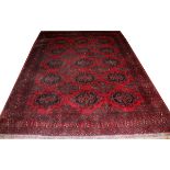 TEKKE BOKHARA WOOL CARPET, W 8' 2", L 11'An all over red ground and design.There is an area of