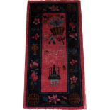 CHINESE WOOL MAT, 3' 10" X 2' 0"Having a plum field with a navy border and designs of flowers, fruit