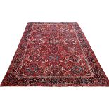 HEREZ HANDWOVEN WOOL CARPET, 20TH C., W 8' 3", L 11' 11"A red ground with a geometric motif.There is