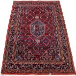 BIJAR DESIGN HANDWOVEN WOOL RUG, W 4', L 6'Having an overall geometric floral motif on a red ground.