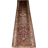 PERSIAN HAMADAN WOOL RUNNER, 9' 8" X 2' 6"Having a navy field with designs in orange, light blue,