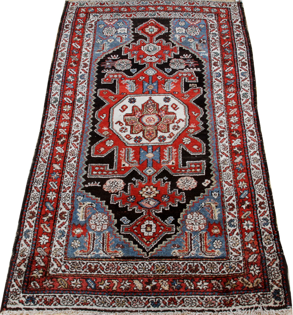 HAMADAN, HANDWOVEN WOOL RUG, W 3' 5", L 5' 6"Having a red ground, three borders, with navy, light