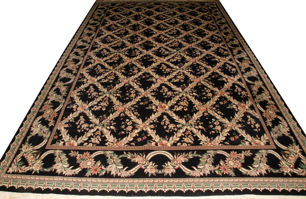 HAND WOVEN WOOL CARPET, 16' 0" X 10' 0"Featuring a black field with overall floral and leaf