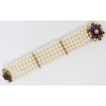 6 1/2 MM PEARL, ENAMEL, AND RUBY BRACELET, L 7 1/2"A five strand pearl bracelet, having a blue