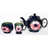 MOORCROFT ANEMONE POTTERY TEAPOT, CREAMER & SUGAR BOWL, H 6"Includes a teapot, creamer and sugar