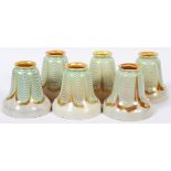 STEUBEN AURENE GLASS SHADES, SIX, H 4 3/4"A set of 6 iridescent glass shades with a pulled feather