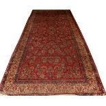 SAROUK DESIGN WOOL ORIENTAL CARPET, SEMI-ANTIQUE, W 8' 7", L 20' 7"Having a red ground, navy