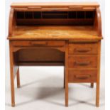 OAK ROLL TOP DESK, H 38.5", L 36", D 22.5"Having four drawers and a roll top that reveals eight