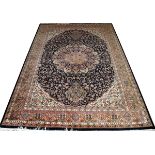 TABRIZ DESIGN HANDWOVEN WOOL CARPET, W 6', L 8' 10"With a navy ground, and a central foliate
