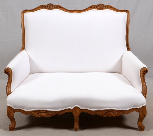 ITALIAN, CARVED FRUITWOOD SETTEE, C1950, H 38", W 48"Italian carved fruitwood settee with cream