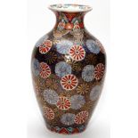 JAPANESE IMARI PORCELAIN VASE, H 9 1/2"Flower motif overall, in shades of blue and red with gilt.