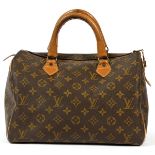 LOUIS VUITTON MONOGRAM CANVAS SPEEDY BAG, W 13"Tan leather handles and trim. Measures W.13" x 8 1/2"