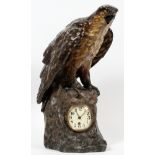 COMPOSITION EAGLE MANTLE CLOCK, H 23"The composition eagle form has a clock at its feet with Roman