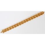 18KT YELLOW GOLD LINK BRACELET, L 8"An 18kt yellow gold foliate linked bracelet. Approximately 42.