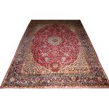 PERSIAN KERMANSHAH WOOL CARPET, ANTIQUE, W 8' 10", L 12' 1"Red field with central floral medallion