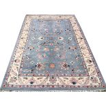 ORIENTAL DESIGN WOOL RUG, W 6', L 9'Having a pale blue field, three borders and overall flower and