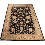 OUSHAK HAND WOVEN PAKISTAN CARPET, W 5' 1" X L 7' 2"A black ground with a beige tone trellis style