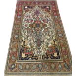 ISFAHAN PERSIAN RUG, C. 1900, 7' 5" X 4' 10"An ivory center ground with a flower and leaf motif in