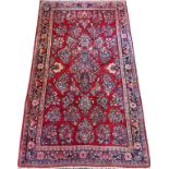 SAROUK PERSIAN RUG, SEMI ANTIQUE, 5' 2" X 3' 3"A red ground with leafy flowering bunches of blue and