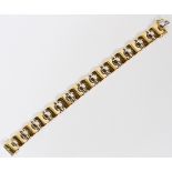 18KT YELLOW AND WHITE GOLD LINK BRACELET, L 7"A two tone 18kt gold bracelet; approximately 27.7