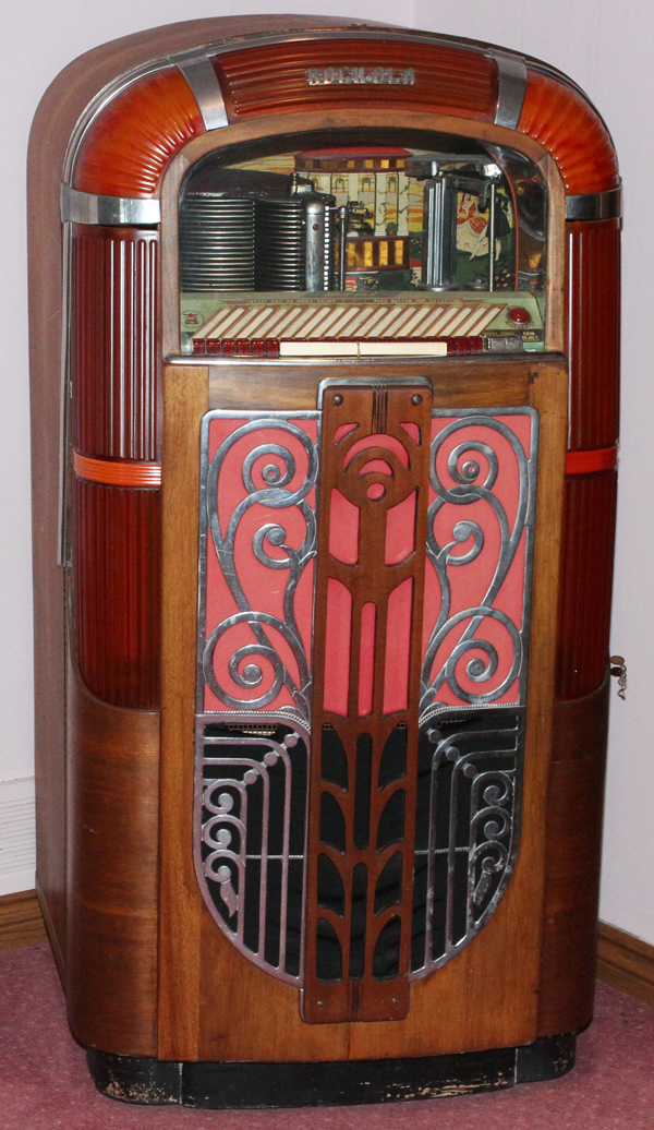 RMC ROCK-OLA JUKEBOX, C.1945, H 58", W 31", D 25"Molded plastic and mahogany case with push
