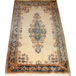 KERMAN PERSIAN HAND WOVEN ORIENTAL RUG, W 3', L 5'An ivory ground with a blue border and central