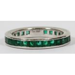 PLATINUM & EMERALD ETERNITY RING, SIZE 3.75A platinum band set with square cut emeralds. Weighing