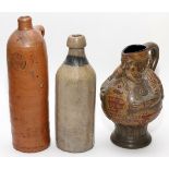 STONEWARE BOTTLES AND FIGURAL PITCHER, 3 PIECES, H 9"-11 1/2"Including 1 Selters bottle, 1 O.F.