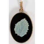 CARVED OPAL AND ONYX PENDANT, H 1 1/8"A carved opal depicting a Native American man mounted on