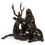 CHINESE BRONZE SCULPTURE, H 8", W 8 1/2"A seated deity on a reindeer.Some minor abrasions to the