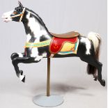 HAND PAINTED WOOD CAROUSEL HORSE, H 55", L 53"Black and white painted body. With saddle. Blanket,