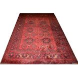TEKKE BOKHARA WOOL CARPET, W 6' 7", L 9' 8"An overall red ground and design, with gold leaves