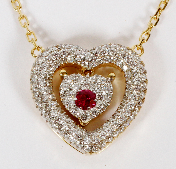 0.60CT DIAMOND AND RUBY HEART NECKLACE, L 17"The double heart form pendant is studded with 0.60cts
