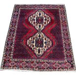 PERSIAN SIRJAN WOOL CARPET, C.1980-90, 6' 5" X 5' 3"having a red ground with three borders with