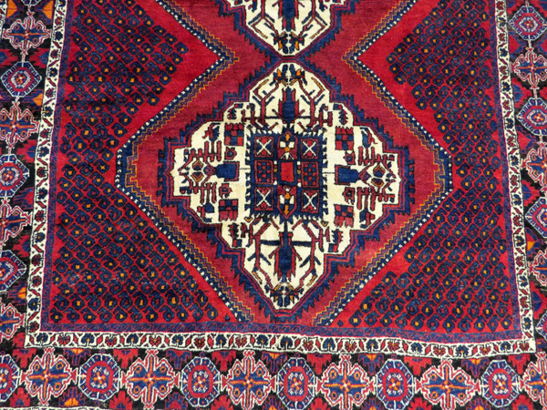 PERSIAN SIRJAN WOOL CARPET, C.1980-90, 6' 5" X 5' 3"having a red ground with three borders with - Image 2 of 4