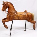 HAND CARVED PINE AMERICAN CAROUSEL HORSE, H 46", W 50"Put together with pegs, carved integral saddle