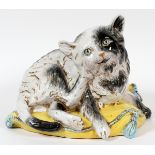 ITALIAN, POTTERY CAT, H 11", W 12"Depicts a hand painted cat sitting on a yellow pillow.